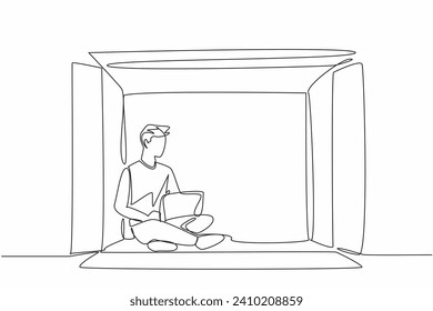 Single continuous line drawing of young man writing on laptop, inside big paper carton box. Work from home concept. Mental health issue. World Introvert Day. Frightened guy being outside box, social