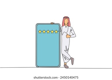 Single continuous line drawing young happy Arabian man stands casually next to a large smartphone, other hand giving a thumbs up gesture. Give review five star. One line design vector illustration