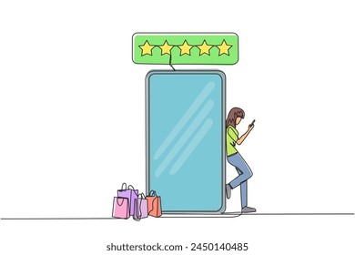 Single continuous line drawing young happy smiling woman leaning on giant smartphone while typing on smartphone. Concept of online shop. Review five gold stars. One line design vector illustration