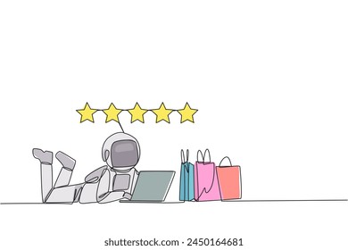 Single continuous line drawing young astronaut on stomach while typing on laptop. Next to the laptop is shopping bag. Give the best review with pleasure. Spaceman. One line design vector illustration