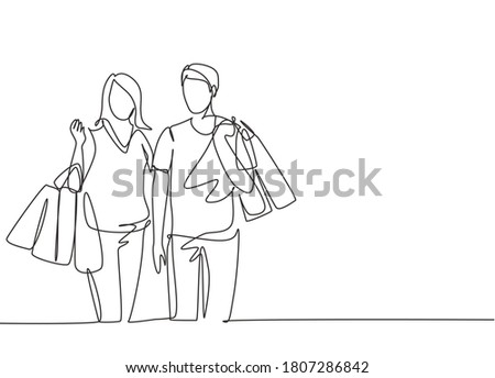 Single continuous line drawing young happy romantic couple holding paper bags while shopping together at mall. Buying fashion and cosmetic concept. One line draw vector graphic design illustration