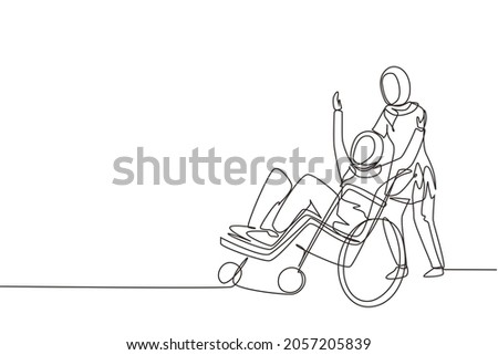 Single continuous line drawing young Arab female volunteer helps disabled old woman, riding on wheelchair in park. Family care, volunteerism, disability care. One line draw design vector illustration