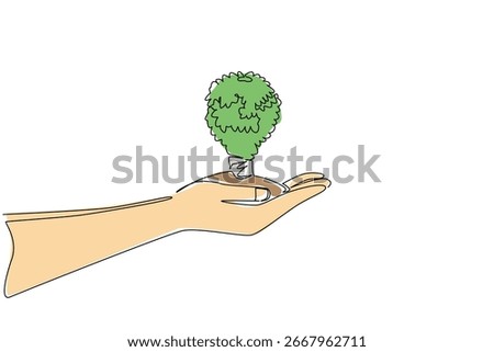 Single line draw of a hand holding a tree shaped like bulb lamp conveys global environment concept for World Environment Day, promoting eco awareness, sustainability, and conservation for the planet.