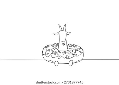 Single line drawing of adored goat for sweet dessert concept shows cute animal sitting inside fancy donut. Simple sketch fits an international food day theme with the playful farm mammal pet animal