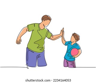 Single line drawing of young happy father and son playing football together on outdoor field and give high five gesture. Parenting concept continuous line draw design vector graphic illustration