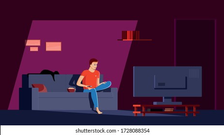 Single man sits in his apartment on the couch, cross-legged, with a remote control in his hand and watches news and movies on TV with a surprised face. A guy in a dark room lit by a TV screen.