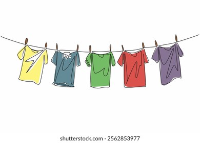 Single one line drawing 5 colorful t-shirts are drying on the clothesline. Adding brightness to the morning when drying. Laundry. National Hanging Out Day. Continuous line design graphic illustration