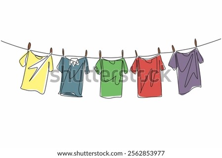 Single one line drawing 5 colorful t-shirts are drying on the clothesline. Adding brightness to the morning when drying. Laundry. National Hanging Out Day. Continuous line design graphic illustration