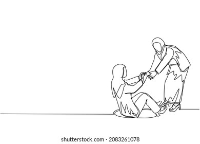 Single one line drawing Arab businesswoman helping her friend by take her out from hole. Two women one of whom helps another. Business struggle. Continuous line draw design graphic vector illustration