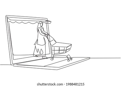 Single one line drawing Arabian woman coming out of canopy laptop screen pushing a shopping cart. Digital lifestyle consumerism concept. Modern continuous line draw design graphic vector illustration