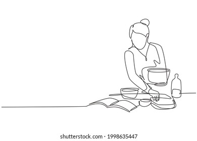 Single one line drawing beautiful woman cooking meal while reading tutorial book on cozy kitchen table at home. Healthy food lifestyle. Modern continuous line draw design graphic vector illustration