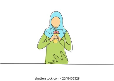 Single one line drawing beautiful Arab woman hold plastic cup and drink iced green tea with straw. Make her refreshing in summer season. Modern continuous line draw design graphic vector illustration