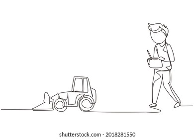 Single one line drawing boy playing with remote-controlled bulldozer toy. Kids playing with electronic toy bulldozer with remote control in hands. Continuous line design graphic vector illustration