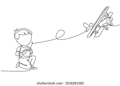 Single one line drawing boy playing with radio control airplane. Smiling kid controlled flying RC aeroplane. Happy childhood, hobby, pastime concept. Modern continuous line draw design graphic vector