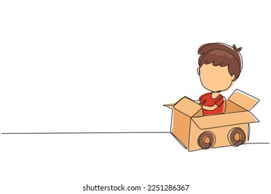 Single one line drawing boy driving cardboard car. Happy child ride on toy car made of cardboard. Creative kids plays with his cardboard car. Continuous line draw design graphic vector illustration
