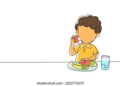 Single one line drawing boy eating fruit. Sitting at table eating apple. Watermelon and banana in tray placed on table at home. Healthy food for kids. Modern continuous line draw design graphic vector