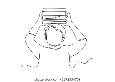 Single one line drawing boy lifting a pile of  on head. World book day concept. Continuous line draw design graphic vector illustration.