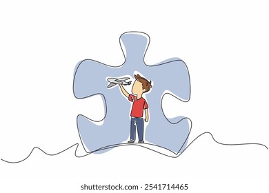 Single one line drawing boy playing with airplanes in the middle of a large puzzle piece. Complexity of mind content. Diversity. World Autism Awareness Day. Continuous line design graphic illustration