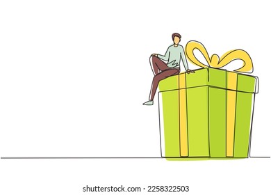 Single one line drawing businessman sitting on big gift box. Big present concept. Man sitting on big box with present. Happy person gets a huge gift. Continuous line draw design vector illustration