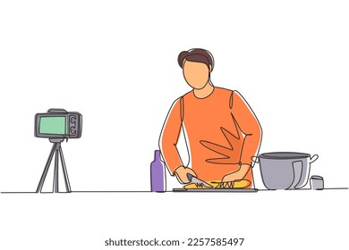 Single one line drawing chef in uniform standing in kitchen and cutting onion while filming himself for blog. On kitchen counter are vegetables, spices. Continuous line draw design vector illustration