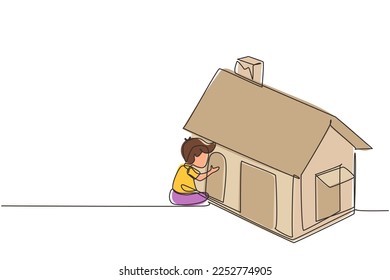 Single one line drawing cute little boy playing in house made of cardboard boxes. Creative child sitting in playhouse. Kid leisure time. Modern continuous line draw design graphic vector illustration