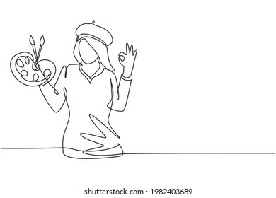 Single one line drawing female artist painter with gesture okay using painting tools such as brushes, canvas, and watercolors in producing art. Continuous line draw design graphic vector illustration