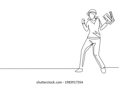 Single one line drawing female film director stands with celebrate gesture holding clapperboard and prepare camera crew for shooting at studio. Continuous line draw design graphic vector illustration