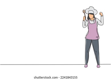 Single one line drawing female chef stands with celebrate gesture, holding spoon and wearing apron prepares ingredients to cook the best dishes. Continuous line draw design graphic vector illustration