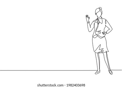 Single one line drawing flight attendant stands in a uniform with gesture okay prepare at the airport with the crew flying to their destination. Continuous line draw design graphic vector illustration