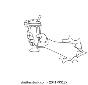 Single one line drawing hand holds glass milkshake with whipped cream through torn white paper. Cold soft drink for summer. Sweet beverage. Tasty and yummy fast food continuous line draw design vector