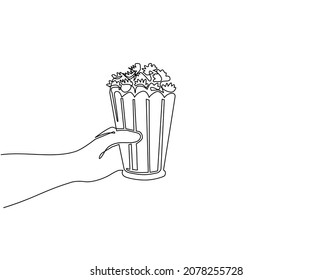 Single one line drawing hand holding popcorn. Human hands holding popcorn box. I love movie cinema icon. Watching movie concept in flat design style. Modern continuous line draw design graphic vector