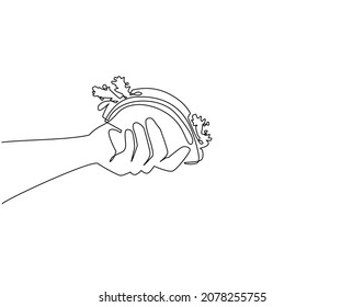 Single one line drawing hand holding mexican taco. Street junk food. Mexican meal. Hand holding tortilla. Bite and snack. For restaurant or cafe drink menu. Continuous line draw design graphic vector