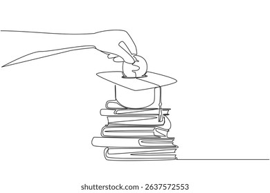 Single one line drawing hand holds coin inserting them into graduation cap and pile of thick books underneath. Serious about education. College Savings Day. Continuous line design graphic illustration