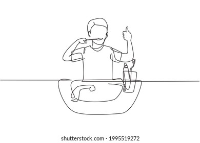 Single one line drawing man brushing his teeth with thumbs up gesture. Routine habits for cleanliness, health, freshness of mouth and teeth. Continuous line draw design graphic vector illustration