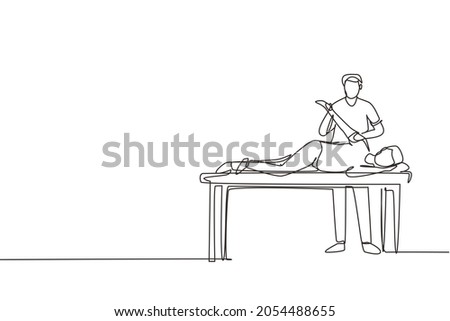 Single one line drawing man patient lying on massage table therapist doing healing treatment massaging injured hand manual physical therapy rehabilitation concept. Continuous line draw design vector