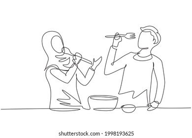 Single one line drawing romantic Arabian couple singing while cooking together, using spoon and fork as microphones. Kitchen fun concept. Modern continuous line draw design graphic vector illustration