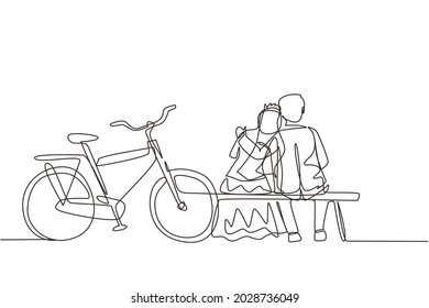 Single one line drawing romantic married couple chatting while sitting on bench. Happy man with suit and woman with wedding dress riding bike. Continuous line draw design graphic vector illustration