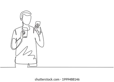 Single one line drawing smiling handsome man looking at mobile phone and holding glass of orange juice while having breakfast at home. Modern continuous line draw design graphic vector illustration