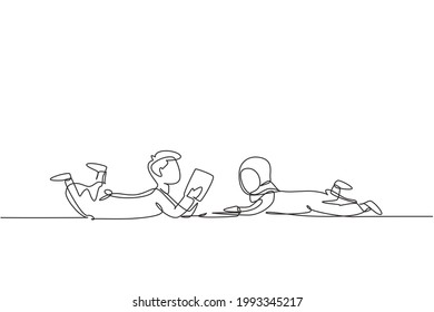 Single one line drawing two Arabian kids boy and girl reading, learning and laying down on the floor. Study at home. Smart students, education. Continuous line draw design graphic vector illustration