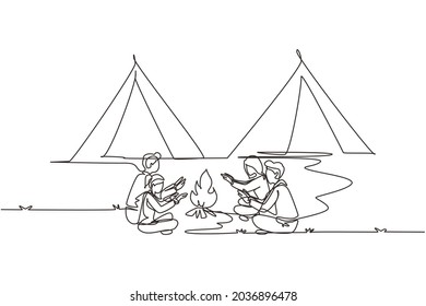 Single one line drawing two couple camping around campfire tents. Group of man woman warm their hands near bonfire sitting on ground. Wild nature trip. Continuous line draw design vector illustration