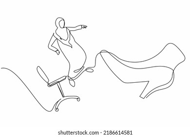 Single one line drawing unhappy small Arabian businesswoman kicked out by big foot from chair. Staff reduction, fired worker. Minimal metaphor. Continuous line draw design graphic vector illustration