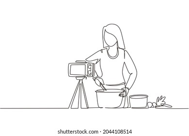 Single one line drawing woman in kitchen preparing dessert at home, stirring dough with spatula. Cooking live streaming. Blogger prepares meal online. Continuous line draw design vector illustration