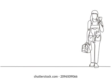 Single one line drawing woman plumber holding wrench and tools box in hands stands isolated. Professional servicewoman character in uniform ready for work. Continuous line draw design graphic vector