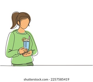 Single one line drawing woman holding glass with delicious milkshake. Young girl holding tasty fresh milk shake with slice of orange. Modern continuous line draw design graphic vector illustration