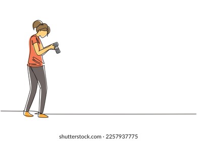 Single one line drawing woman photographers or paparazzi taking photo with digital cameras with angles. Girl Journalists or reporters checking pictures. Continuous line draw design vector illustration