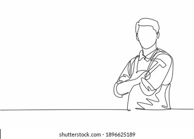 Single one line drawing young male carpenter cross arm on chest and holding hammer. Professional work profession and occupation minimal concept. Continuous line draw design graphic vector illustration