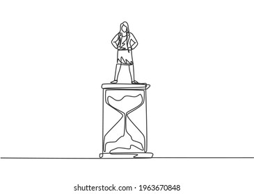 Single one line drawing of young business woman standing above hourglass. Sandglass to show time management business minimalist concept. Modern continuous line draw design graphic vector illustration.