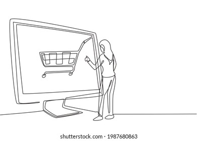 Single one line drawing young woman shopping online via giant computer screen with shopping cart inside. Digital lifestyle, consumerism concept. Continuous line draw design graphic vector illustration