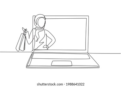 Single one line drawing young Arabian woman coming out of laptop screen holding shopping bags. Digital lifestyle and consumerism concept. Modern continuous line draw design graphic vector illustration