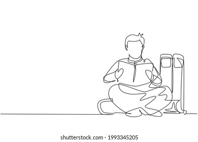 Single one line drawing young Arabian male reading, learning and sitting on big books. Study in library. Literature fans or lovers. Modern continuous line draw design graphic vector illustration